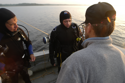 Pat Lohman and Jay Sisson confer with Rocky Geyer after locating his lost tripod.