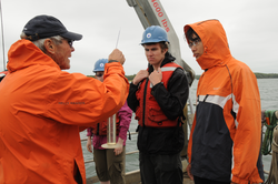 George Hampson showing student different water testing techniques.