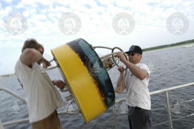 Malcolm Scully and Rocky Geyer move a mooring to a safe location.