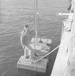 Ed Chute with large buoy at WHOI dock.