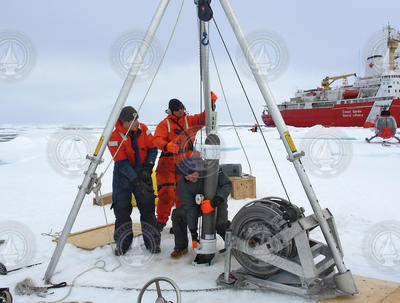 Deploying an ITP through the ice hole in the Arctic. Weller research.