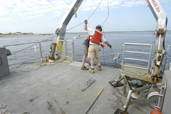 Dave Ralston (partially obscured) and Jay Sisson during a mooring recovery