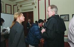 Ruth Curry (left) speaking with a guest at the briefing