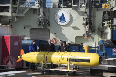 The NSF visitors are shown a REMUS 6000 on the dock.