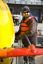 Sean Kelley preparing Sentry for launch at the WHOI dock.