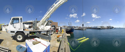 HROV Nereus suspended into water by crane off the dock during tests.
