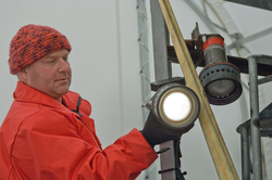 Tim Shank examine a light mounted onto CAMPER.