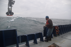 Glen Gawarkiewicz with CTD LARS extended over the surface during rough seas.