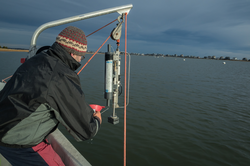 Rocky Geyer recovering water from a Niskin bottle on the South River.