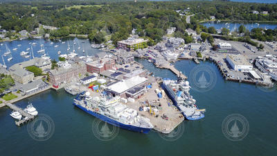 Aerial of Woods Hole village and the WHOI dock with three vessels.