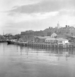 View of WHOI dock, Bigelow Building, and MBL in distance.