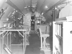 Interior view of C54Q aircraft, seats and work table in view