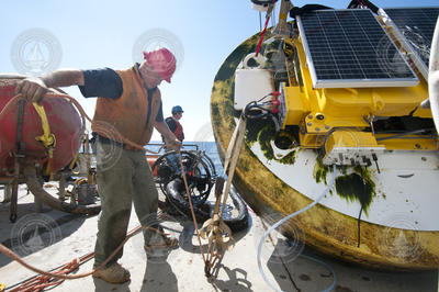 Jim Ryder securing the recovered buoy to the deck.