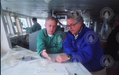 Dudley Foster and Charlie Charley looking over charts.