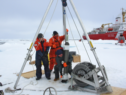 Deploying an ITP through the ice hole in the Arctic. Weller research.