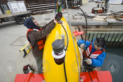 Sean Kelley and Justin Fujii preparing AUV Sentry for dock tests.