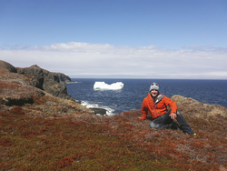 Dr. Alan Condron with iceberg and the Labrador Sea in the background.