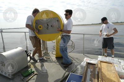 Malcolm Scully and Jim Lerczak carrying a recovered buoy