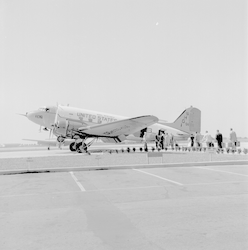 Full view R4D aircraft, line of people boarding