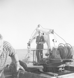 Jacques Cousteau standing aboard Calypso