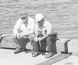 Carl Young (l) and Bobby Weeks sitting on dock