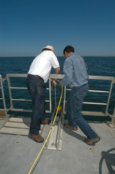Jim Doutt and Sachin Goyal deploying sidescan sonar instrument.