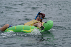 Turtle man was disqualified for using a flotation device.