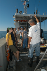 Hovey Clifford (white shirts) discussing sediment sampling with students.