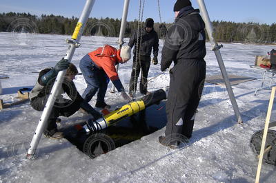 The team positioning REMUS vehicie into the ice hole for deployment.