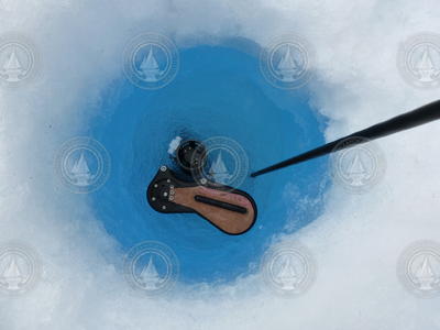 Top of an Ice-Tethered Profiler (ITP) as it descends through an ice hole.