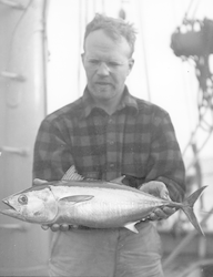 Frank Mather holding a small tuna caught from Atlantis
