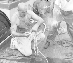 Arvid Karlson splicing rope on Atlantis deck.