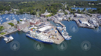 Aerial of Woods Hole village and the WHOI dock with three vessels.