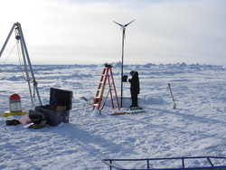 Kris Newhall working on a wind generator out on the ice.