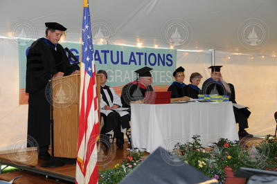Jim Yoder speaking from podium during Commencement.