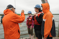 George Hampson showing student different water testing techniques.