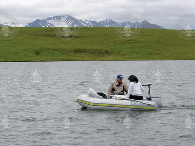 Geochemists working at an Alaskan lake.