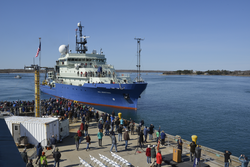 Dock full of spectators welcoming R/V Neil Armstrong to its home port of WHOI.