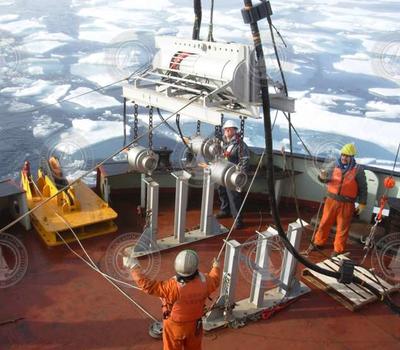 A tow sled with air guns is lifted from its cradle.