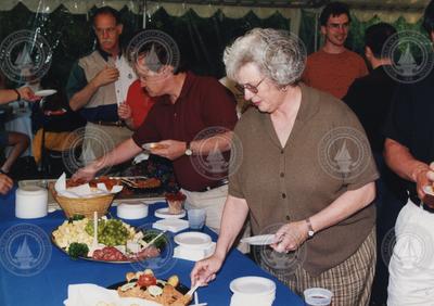 People engaged at the buffet at the 1998 Graduate Reception.