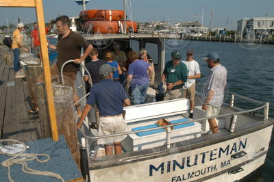Minuteman skipper Emile Tietje (blue shirt) escorting guests off vessel.