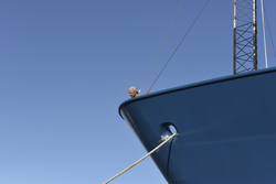 Bosun Patrick Hennessy monitors the departure from the ship's bow.