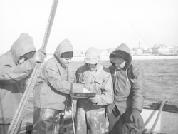 Lloyd "Tex" Hoadley [second from left] aboard Asterias