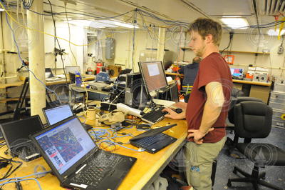 James Kinsey monitoring AUV Sentry activity on a laptop.