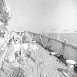 Brooks Coughlin washing clothes on fore deck of Atlantis.