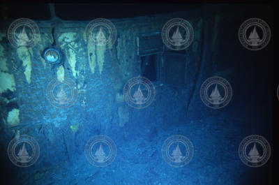 Rusticles, icicles of rust, draping over portholes on RMS Titanic wreck.