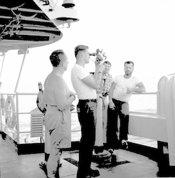 Group on deck of Chain, taking measurements