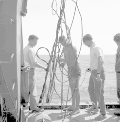 Dick Colburn (left) and unidentified men deploying instrument, sorting cable