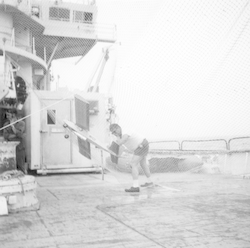 Frederick Fritz Hess and model airplane in capture net