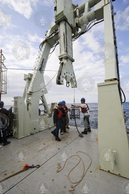 Scientists and crew deploying sediment traps off R/V Knorr.